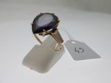 an image of a ring with a purple stone on top of it