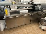 a kitchen with a lot of stainless steel counter tops
