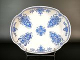 a blue and white plate sitting on a black table