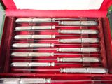 a lot of silverware in a red box on a table