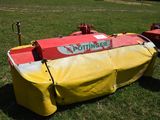 a yellow and red boat that is sitting in the grass