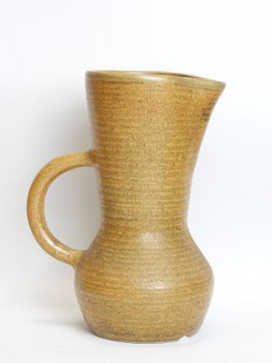 a brown vase with a handle on a white background