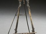 an old fashioned easel with a wooden stand and a metal handle