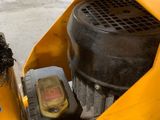 a close up of a small yellow machine with a brush