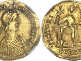 a gold coin with an image of a man holding a sword