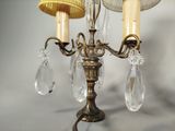 two candles that are hanging from a chandelier
