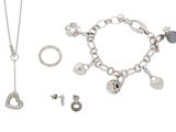 a necklace, bracelet, and earring set on a white background