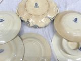 four plates and a bowl sitting on a table