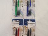 four different colored pens sitting on top of each other on a white surface