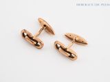 two pairs of rose gold cufflinks on a white background