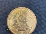 an image of a gold coin sitting on top of a blue cloth