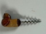 a cork and a corkscue on a white surface