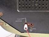 a close up of a metal object with a red cord