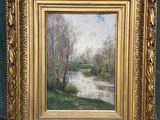 une image représentant un tableau représentant une rivière, dans un cadre doré