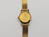 a close up of a gold wrist watch on a white surface