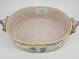 a bowl with a handle that has a painting on it