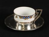 a cup and saucer on a plate on a black background