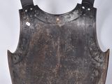 an old, worn, metal armor with a black belt