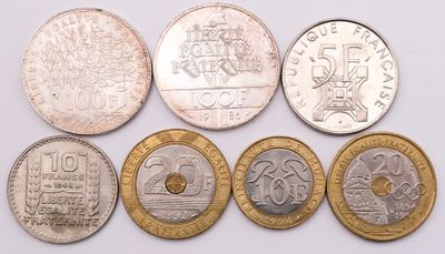 six different types of coins are shown on a white surface