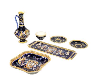 a blue and gold table setting with a vase, plates, and trays