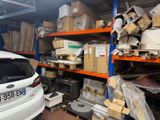 a car that is parked in a garage next to a shelf
