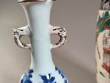 two vases sitting side by side on a table