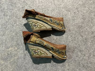 two pairs of shoes that are sitting on the floor