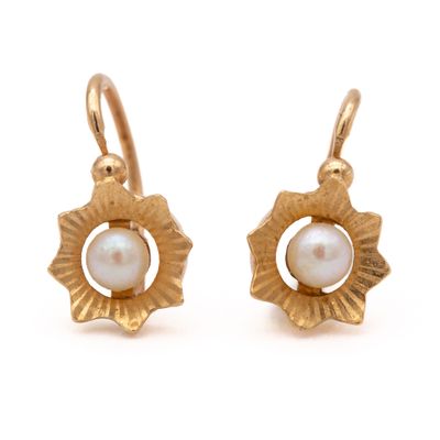 gold plated earrings with a pearl in the center