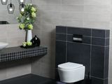 a bathroom with a toilet, sink, and mirror in it