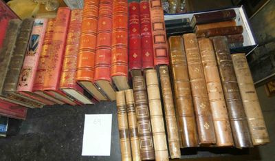 a lot of books that are stacked on top of each other