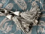 a close up of a blanket with a tassel on top of it