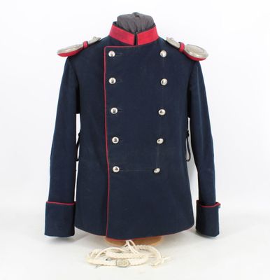 a blue coat with red trims and buttons on a mannequin dummy