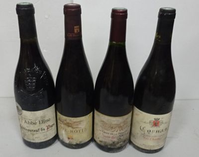 four bottles of wine are lined up on a table