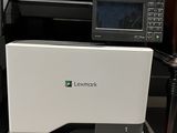 the printer is sitting on top of the desk next to the printer