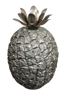 a silver vase with a pineapple on top of it