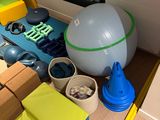 a table with a ball, boxes, and other toys on it