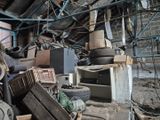 a pile of junk inside of a building with a lot of tires
