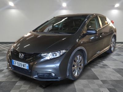 the honda civic is parked in a showroom with a checkered floor