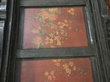 a picture of a window in a room that has red and yellow flowers on it