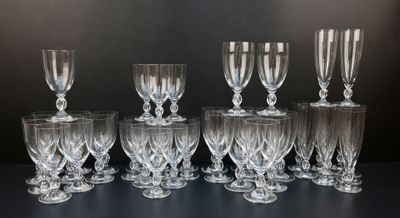twelve wine glasses lined up in a row on a black surface