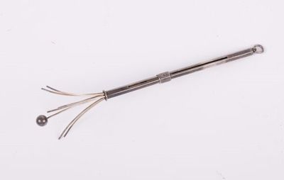 a close up of a metal object on a white surface