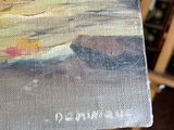 a person holding a painting in their hand in front of a easel