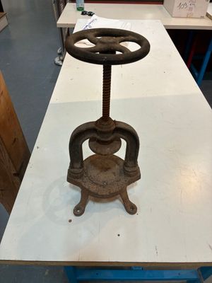 a table with a metal object on it in a room