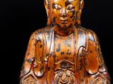 an image of a statue of a person sitting in a lotus position