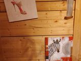 a bathroom with a toilet, sink, and pictures on the wall