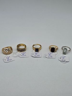 five different types of rings and tags on a white surface