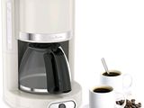 une cafetière avec une tasse de café à côté