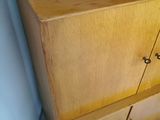 a wooden cabinet with two drawers and a door