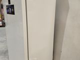 a white refrigerator sitting on a pallet in a warehouse