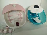 two electric foot massagers sitting on a shelf next to each other